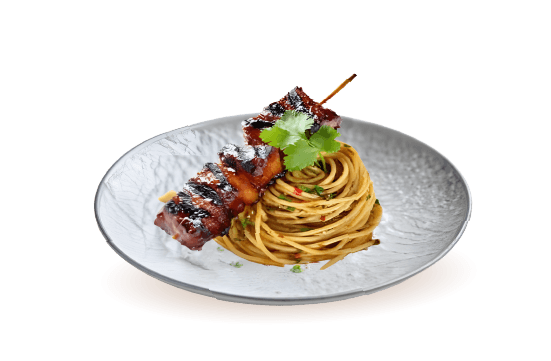 A gourmet entrée from the Mozaic catering menu featuring a perfectly swirled nest of seasoned spaghetti pasta paired with a grilled, glazed meat skewer and garnished with a fresh cilantro leaf.